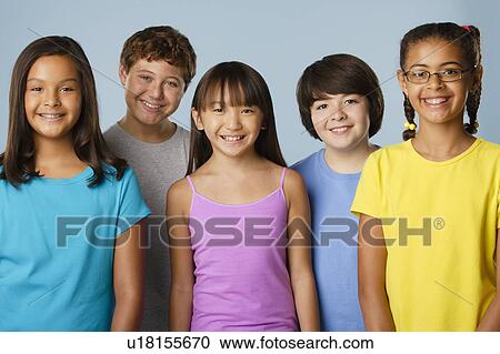 Stock Image - Studio portrait of children (10-11, 12-13). Fotosearch
