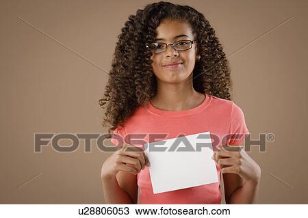 Studio portrait of girl (10-11) holding blank sheet of paper View Large Photo Image Stock Image - Studio portrait of girl (10-11) holding blank sheet of paper. Fotosearch