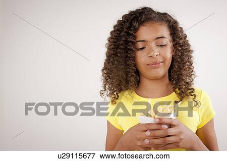 Studio portrait of girl (10-11) holding french fries View Large Photo Image Stock Photo - Studio portrait of girl (10-11) holding french fries. Fotosearch