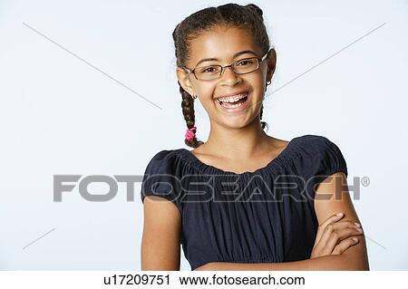 Studio portrait of girl (10-11) laughing View Large Photo Image Stock Image - Studio portrait of girl (10-11) laughing. Fotosearch