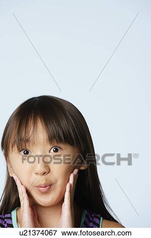 Studio portrait of girl (10-11) raising eyebrows View Large Photo Image Stock Photo - Studio portrait of girl (10-11) raising eyebrows. Fotosearch