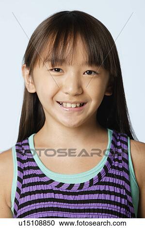 Stock Image - Studio portrait of girl (10-11). Fotosearch