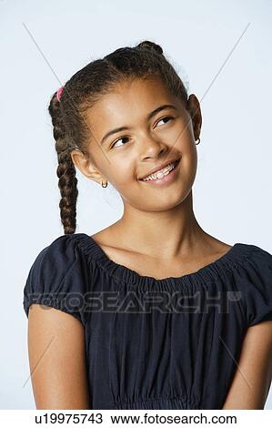 Stock Image - Studio portrait of girl (10-11). Fotosearch