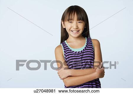 Stock Image - Studio portrait of girl (10-11). Fotosearch