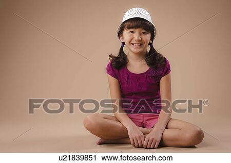 Studio portrait of girl (10-11) wearing hat View Large Photo Image Stock Image - Studio portrait of girl (10-11) wearing hat. Fotosearch
