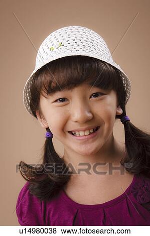 Studio portrait of girl (10-11) wearing hat View Large Photo Image Stock Photo - Studio portrait of girl (10-11) wearing hat. Fotosearch