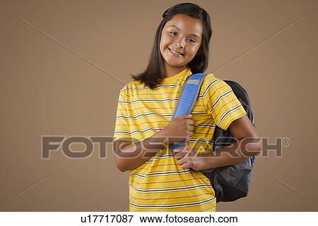 Studio portrait of girl (10-11) wearing backpack View Large Photo Image Stock Photo - Studio portrait of girl (10-11) wearing backpack. Fotosearch