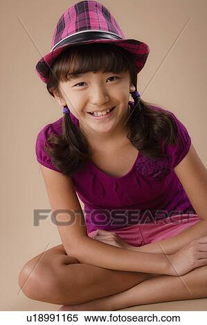 Studio portrait of girl (10-11) wearing hat View Large Photo Image Stock Photography - Studio portrait of girl (10-11) wearing hat. Fotosearch