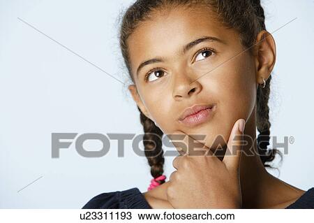 Studio portrait of girl (10-11) with hand on chin, looking up View Large Photo Image Stock Image - Studio portrait of girl (10-11) with hand on chin, looking up. Fotosearch