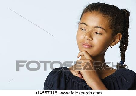 Studio portrait of girl (10-11) with hand on chin View Large Photo Image Stock Photo - Studio portrait of girl (10-11) with hand on chin. Fotosearch
