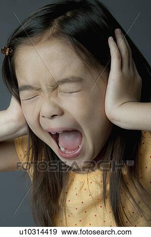 Studio portrait of girl (8-9) covering ears and screaming View Large Photo Image Stock Photo - Studio portrait of girl (8-9) covering ears and screaming. Fotosearch