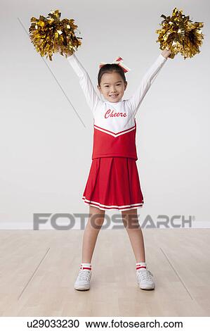 Studio portrait of girl (8-9) cheerleading View Large Photo Image Stock Image - Studio portrait of girl (8-9) cheerleading. Fotosearch
