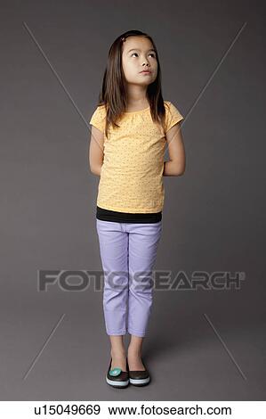 Stock Photo - Studio portrait of girl (8-9). Fotosearch