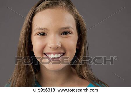 Stock Photo - Studio portrait of girl (8-9). Fotosearch