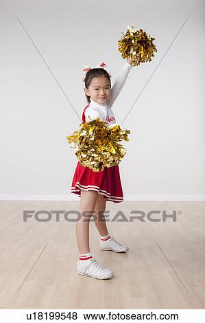 Studio portrait of girl (8-9) cheerleading View Large Photo Image Stock Photo - Studio portrait of girl (8-9) cheerleading. Fotosearch