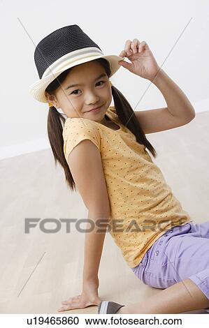 Studio portrait of girl (8-9) wearing hat View Large Photo Image Stock Image - Studio portrait of girl (8-9) wearing hat. Fotosearch