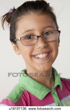 Studio portrait of girl (8-9) wearing eyeglasses View Large Photo Image Stock Photograph - Studio portrait of girl (8-9) wearing eyeglasses. Fotosearch