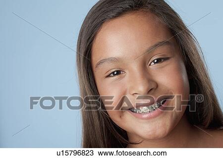 Studio portrait of girl smiling (10-11) View Large Photo Image Stock Image - Studio portrait of girl smiling (10-11). Fotosearch
