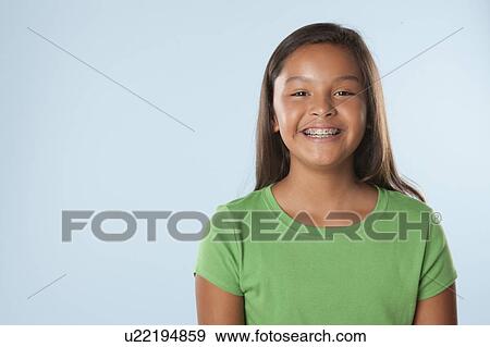 Studio portrait of girl smiling (10-11) View Large Photo Image Stock Photo - Studio portrait of girl smiling (10-11). Fotosearch