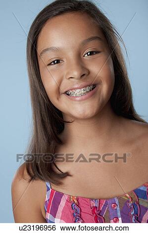 Studio portrait of girl smiling (10-11) View Large Photo Image Stock Photograph - Studio portrait of girl smiling (10-11). Fotosearch