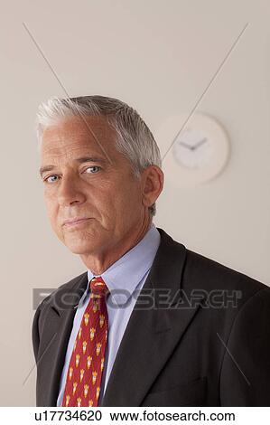 Stock Image - Studio portrait of senior businessman. Fotosearch