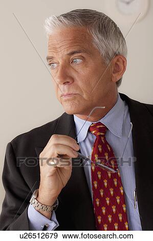 Stock Photo - Studio portrait of senior businessman. Fotosearch