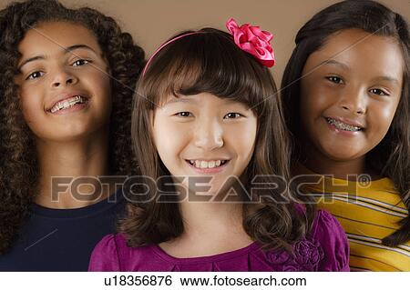 Studio portrait of three girls (10-11) View Large Photo Image Stock Photograph - Studio portrait of three girls (10-11). Fotosearch