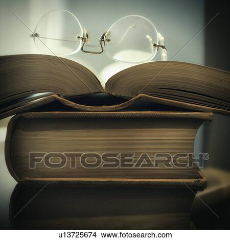 Picture - Studio shot of books and eyeglasses. Fotosearch