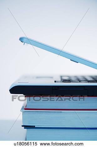 Stock Photography - Studio shot of books and laptop. Fotosearch
