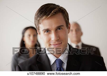 Studio shot of business people, focus on young business man View Large Photo Image Stock Image - Studio shot of business people, focus on young business man. Fotosearch
