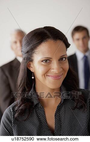 Studio shot of business people, focus on mid adult business woman View Large Photo Image Stock Image - Studio shot of business people, focus on mid adult business woman. Fotosearch