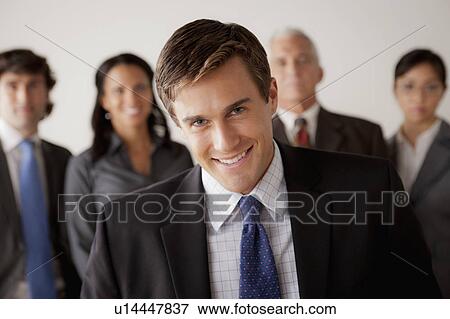 Stock Photo - Studio shot of business people, focus on young business man. Fotosearch
