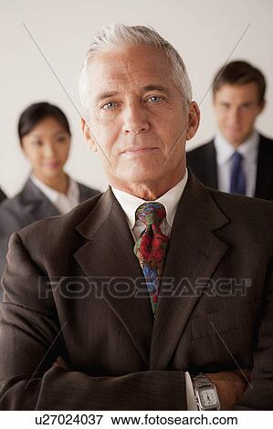 Studio shot of business people, focus on senior business man View Large Photo Image Stock Photo - Studio shot of business people, focus on senior business man. Fotosearch