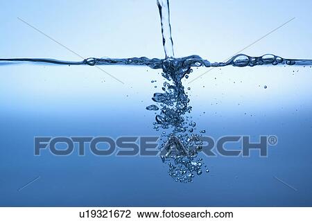 Stock Image - Studio shot of clear blue water. Fotosearch