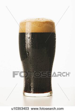 Stock Image - Studio shot of dark beer in glass. Fotosearch