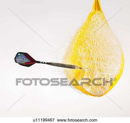 Stock Photo - Studio shot of dart puncturing water-filled balloon. Fotosearch