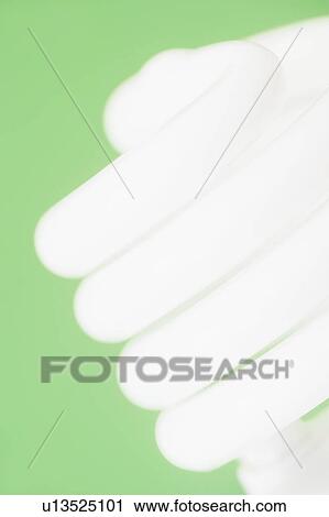 Studio shot of energy efficient lightbulb on green background View Large Photo Image Stock Image - Studio shot of energy efficient lightbulb on green background. Fotosearch