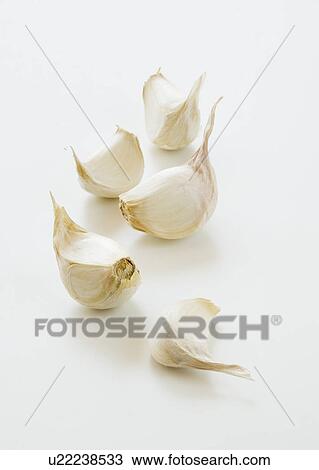 Stock Image - Studio shot of fresh garlic cloves. Fotosearch