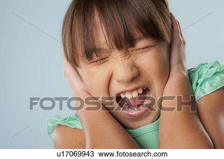 Stock Image - Studio shot of girl (10-11) shouting. Fotosearch