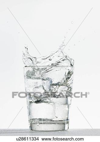 Picture - Studio shot of glass of water with splash. Fotosearch