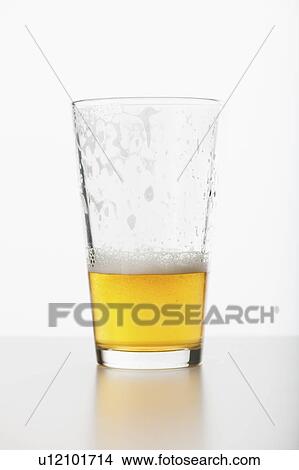 Studio shot of half full beer glass View Large Photo Image Picture - Studio shot of half full beer glass. Fotosearch