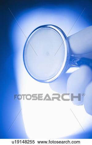 Stock Photography - Studio shot of hand holding stethoscope. Fotosearch