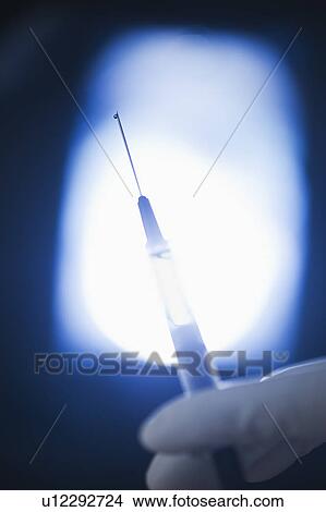 Studio shot of hand holding syringe View Large Photo Image Picture - Studio shot of hand holding syringe. Fotosearch