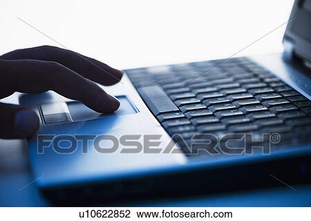 Studio shot of hand using laptop View Large Photo Image Stock Image - Studio shot of hand using laptop. Fotosearch