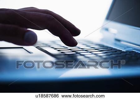 Studio shot of hand using laptop View Large Photo Image Stock Photograph - Studio shot of hand using laptop. Fotosearch