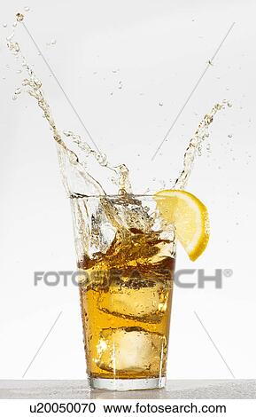Stock Image - Studio shot of iced tea with splash. Fotosearch