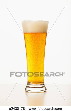 Stock Image - Studio shot of pale ale in glass. Fotosearch