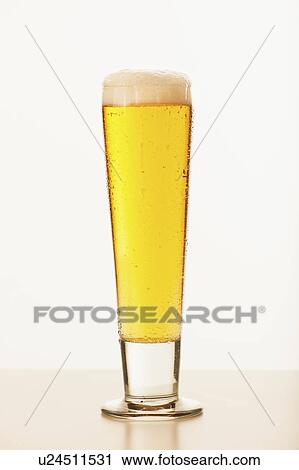 Stock Image - Studio shot of pale ale in glass. Fotosearch