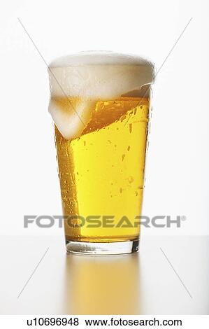 Stock Photo - Studio shot of pale ale in glass. Fotosearch