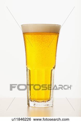 Stock Photograph - Studio shot of pale ale in glass. Fotosearch